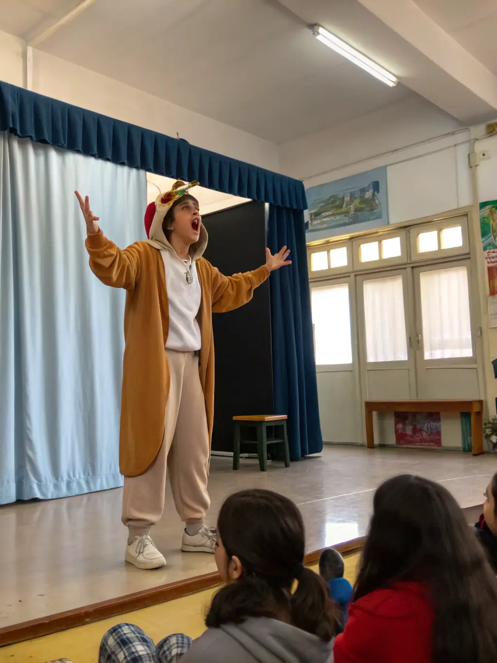 Students actively participating in an educational theater performance, illustrating their curiosity and learning.